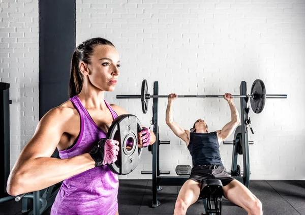 Sportspeople training in gym — Stock Photo