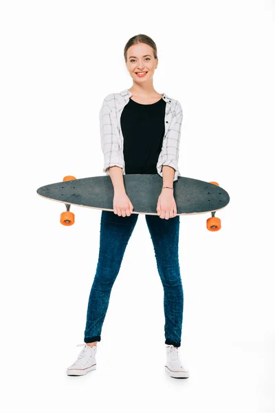 Smiling girl holding skateboard — Stock Photo