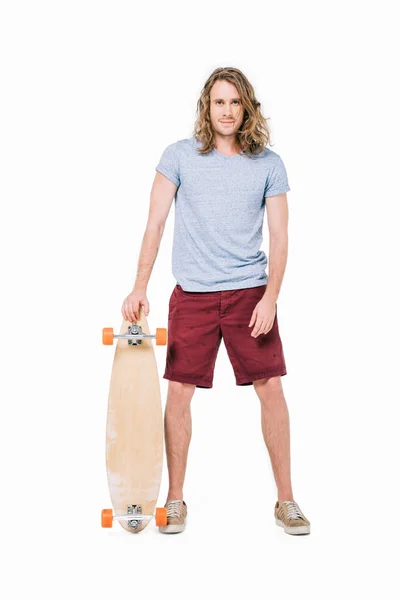 Handsome young man with skateboard — Stock Photo