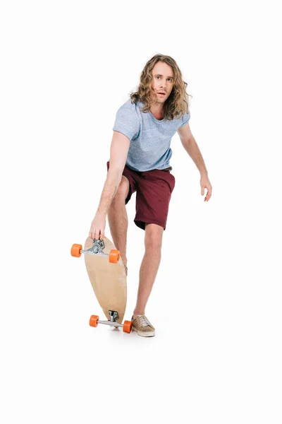 Handsome young man with skateboard — Stock Photo