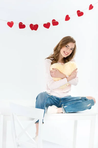 Woman with heart shaped pillow — Stock Photo, Image