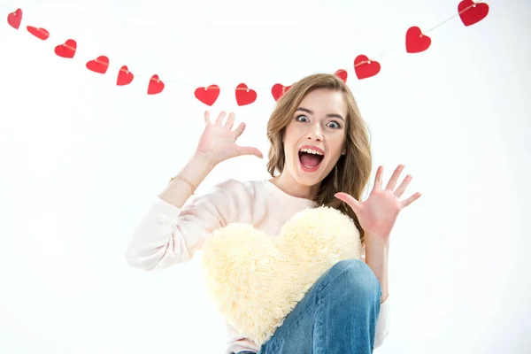 Woman with heart shaped pillow — Free Stock Photo