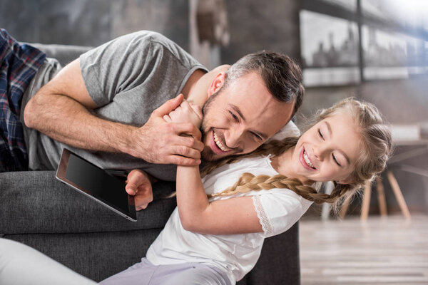 Отец и дочь с помощью цифрового планшета
 