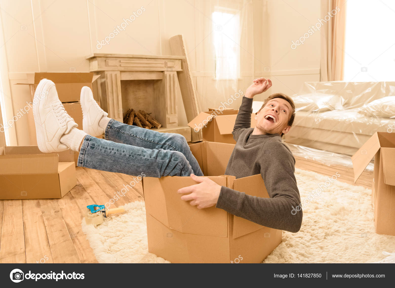 Man sitting in cardboard box Stock Photo by ©TarasMalyarevich 141827850