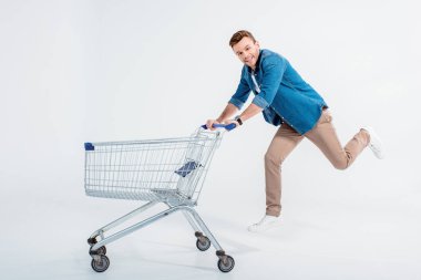 Young man with shopping trolley clipart