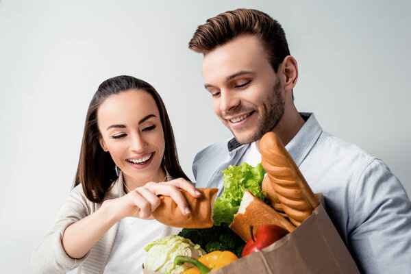 Young couple with grocery bag