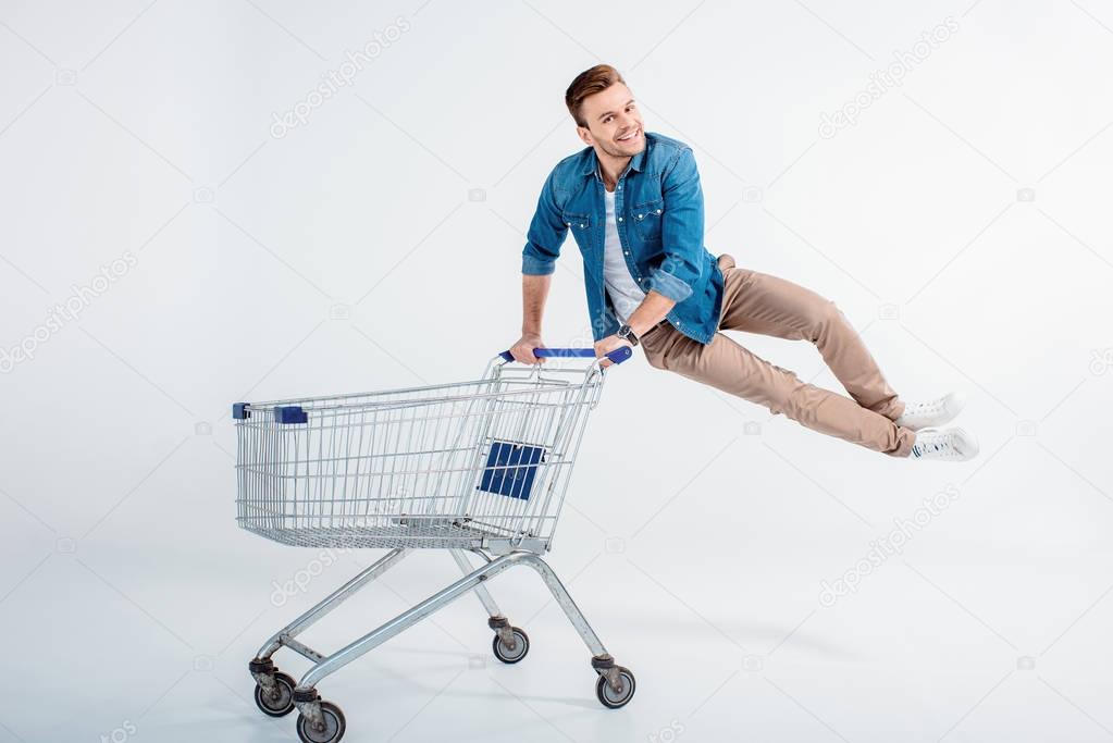 Young man with shopping trolley