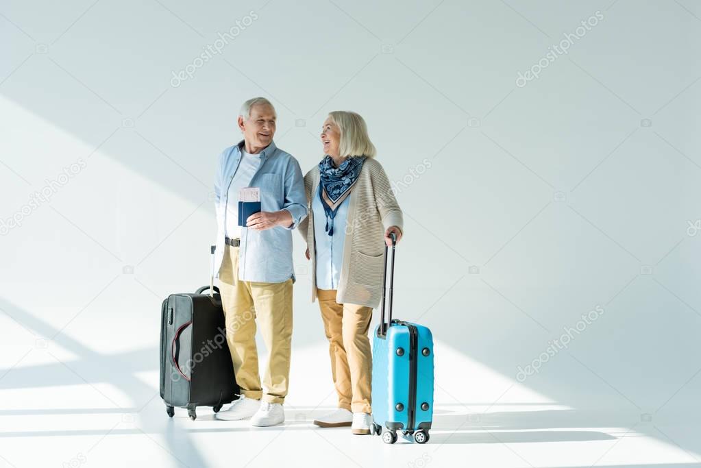 senior couple with traveling bags