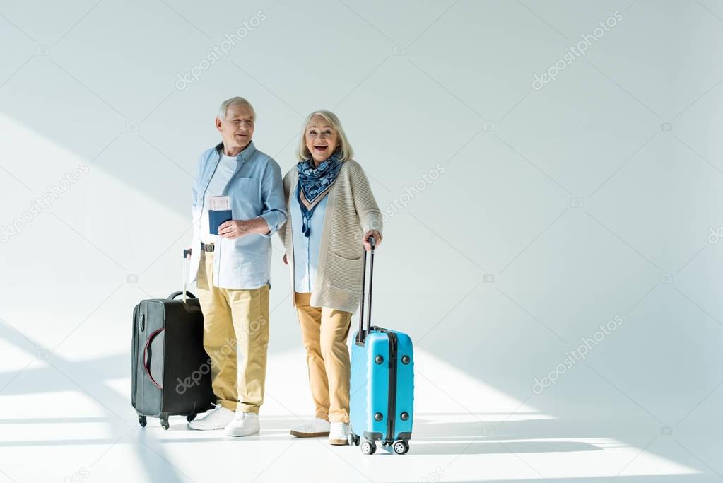 senior couple with traveling bags