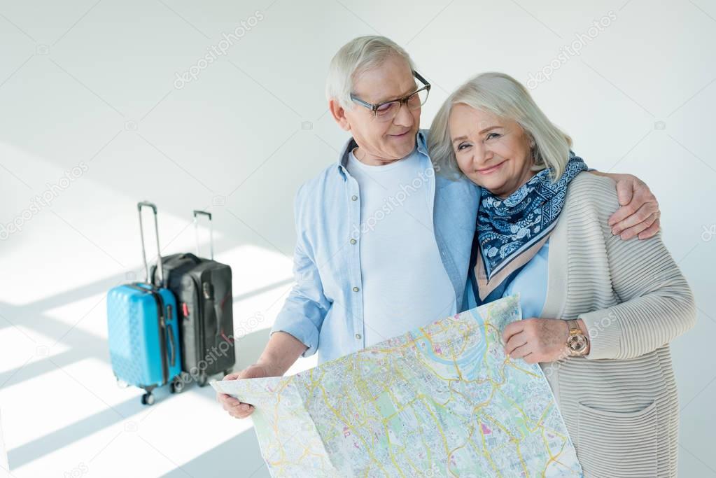 senior couple with traveling map