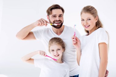 Family holding toothbrushes   clipart