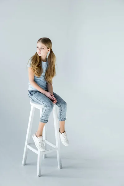 Girl sitting on chair — Stock Photo, Image