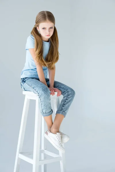 Girl sitting on chair — Stock Photo, Image