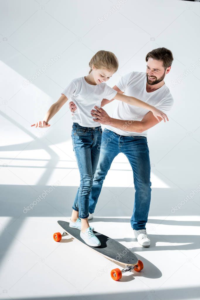 Father and daughter with skateboard 