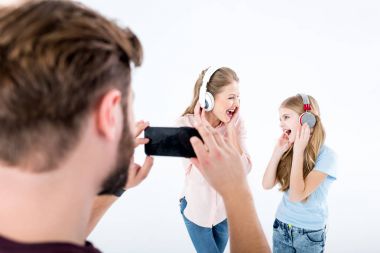 father taking photo of mother and daughter clipart