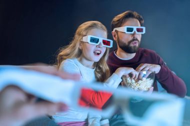 Father and daughter in 3d glasses  clipart