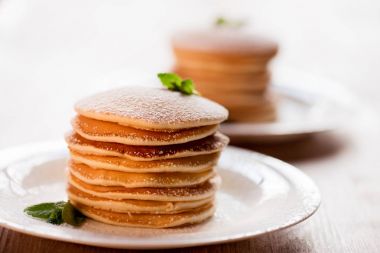 Pancakes with mint and powdered sugar clipart