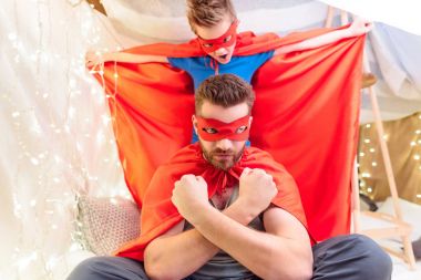 Father and son in superhero costumes  clipart