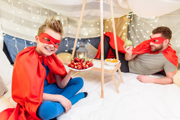 Father and son in superhero costumes 
