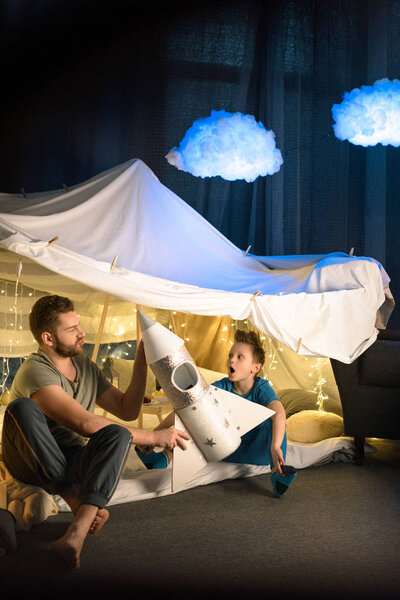 Father and son in blanket fort 