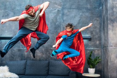 father and son in superhero costumes clipart