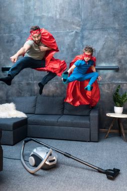 father and son in superhero costumes clipart
