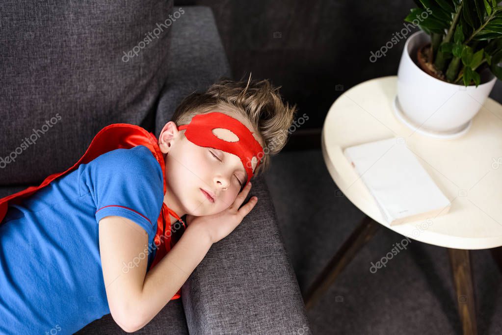 boy in superhero costume sleeping 