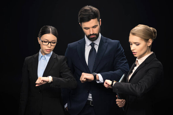 business people looking at watches