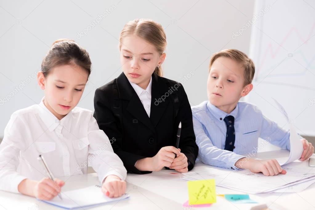 Cute children working with papers