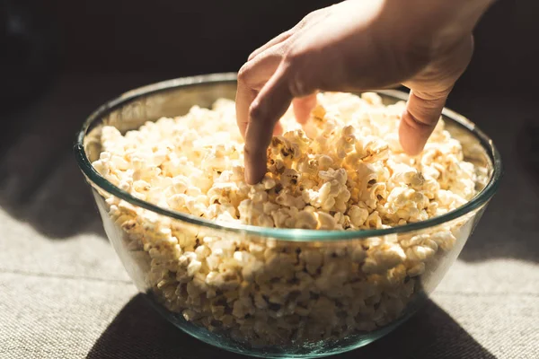 Human hand taking popcorn — Free Stock Photo