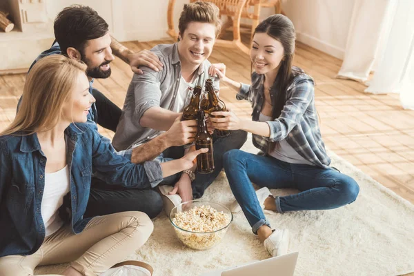 Two couples watching movie on laptop — Stock Photo, Image