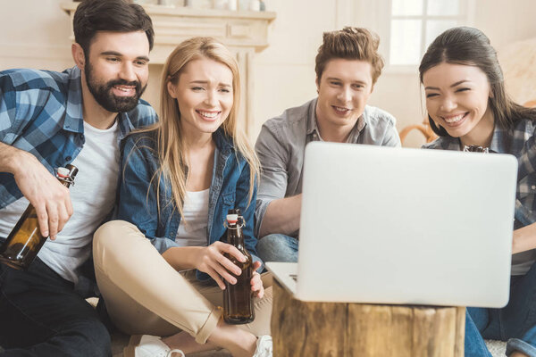 Two couples watching movie on laptop