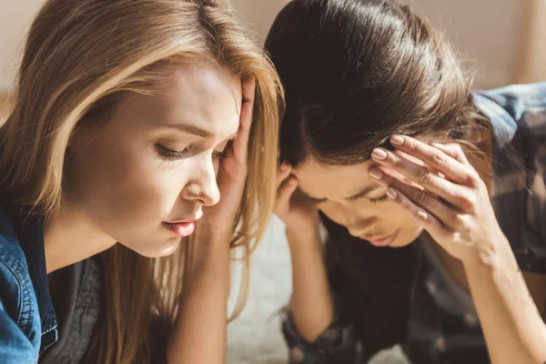 Women lying on floor with headache — Stock Image Women lying on floor with headache Stock Picture