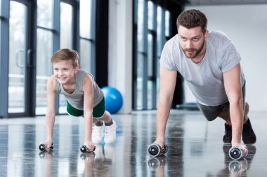 Man and boy doing push ups  clipart