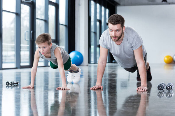 Man and boy doing push ups 