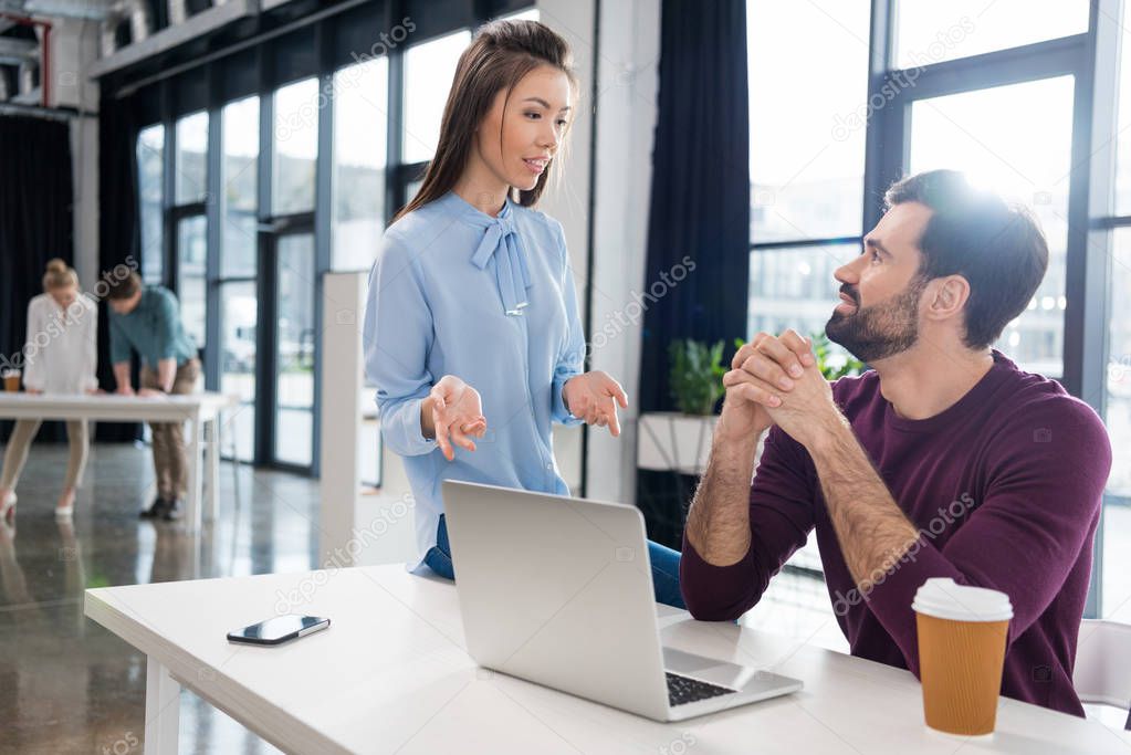 Businesspeople working with laptop  