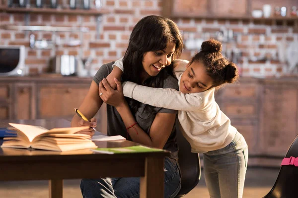 Little girl hugging mother — Stock Photo, Image