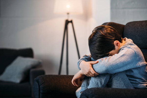 boy sitting in armchair 