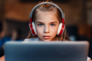 little girl in headphones