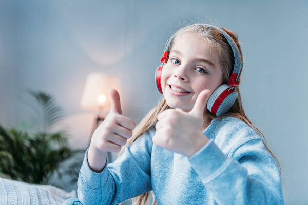 little girl in headphones