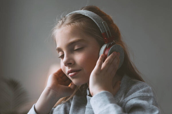 kid girl listening music in headphones