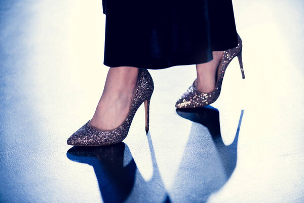 woman in glitter high heels