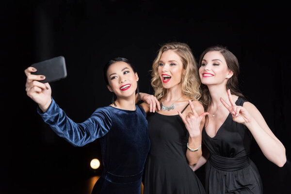 women taking selfie on smartphone