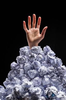 Hand reaching out from heap of papers clipart