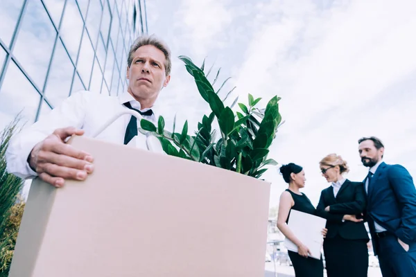 Fired businessman with cardboard box — Stock Photo, Image