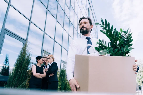 Fired businessman with cardboard box — Stock Photo, Image