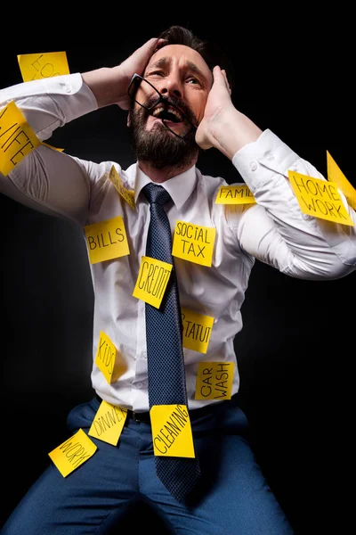 Stressed businessman with sticky notes — Free Stock Photo