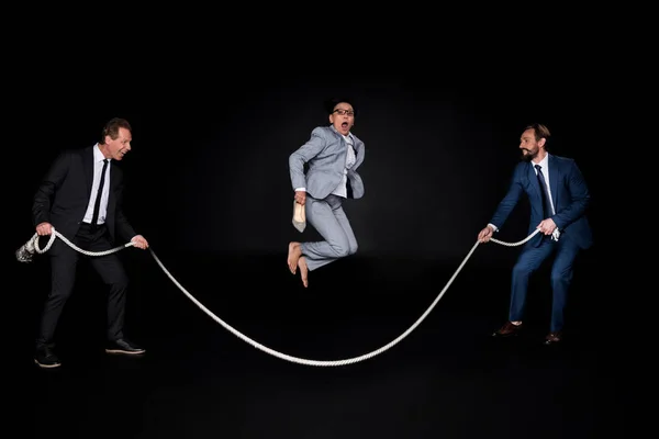 Business colleagues having fun with rope — Stock Photo, Image