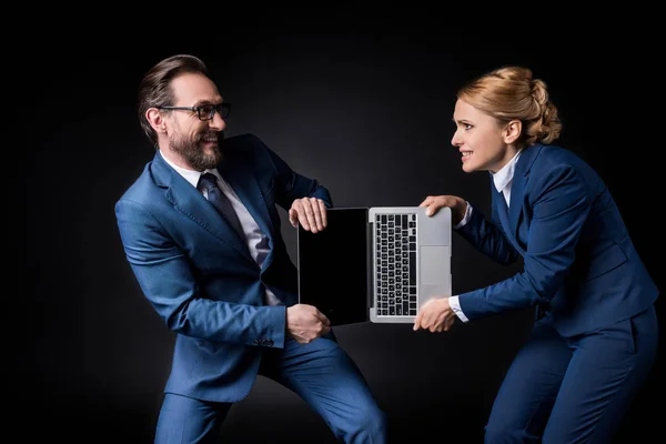 Business colleagues fighting for laptop — Stock Photo, Image