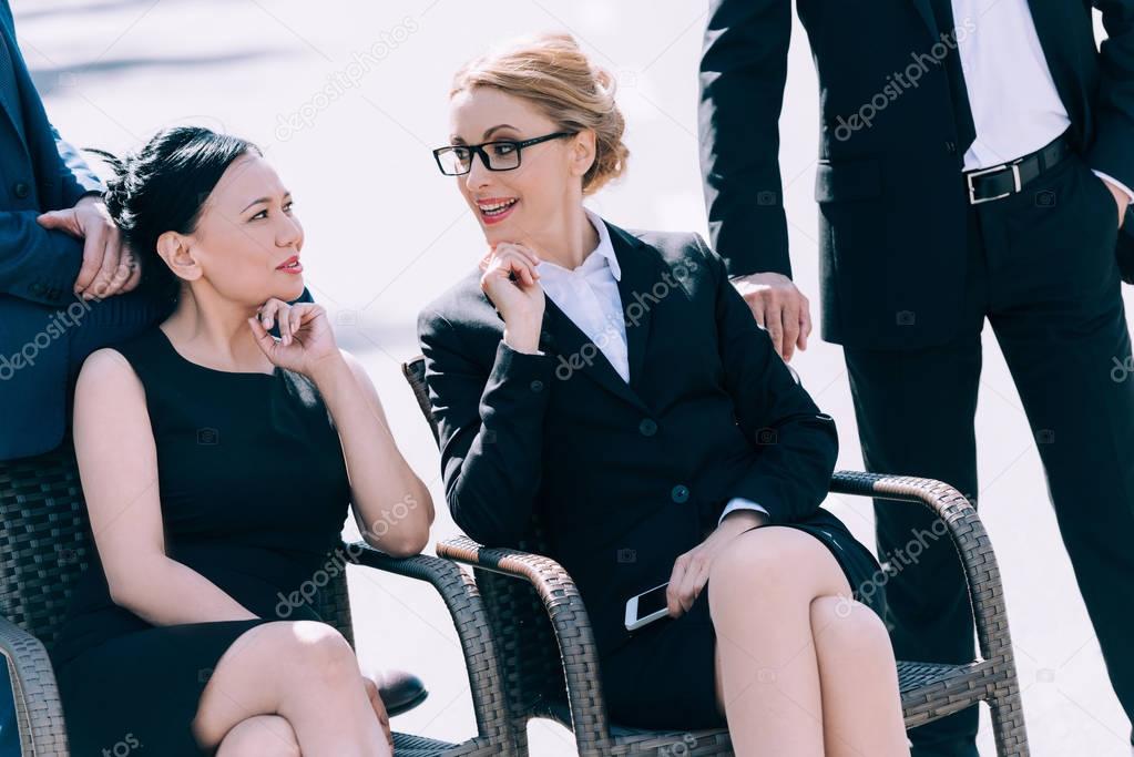 mature businesswomen sitting on chairs